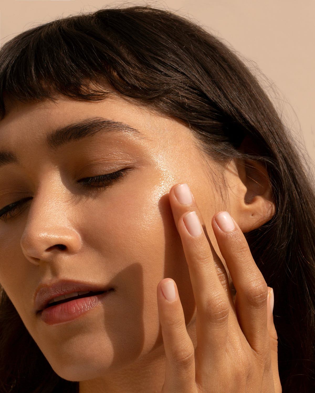 woman touching skin on face
